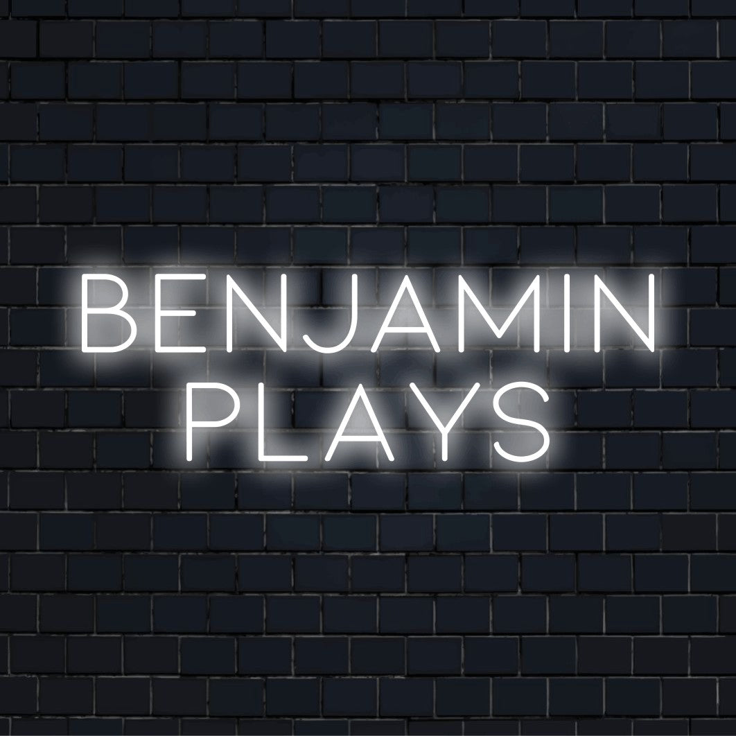 Benjamin Plays Personalized LED Neon Sign, bright neon glow against black brick wall