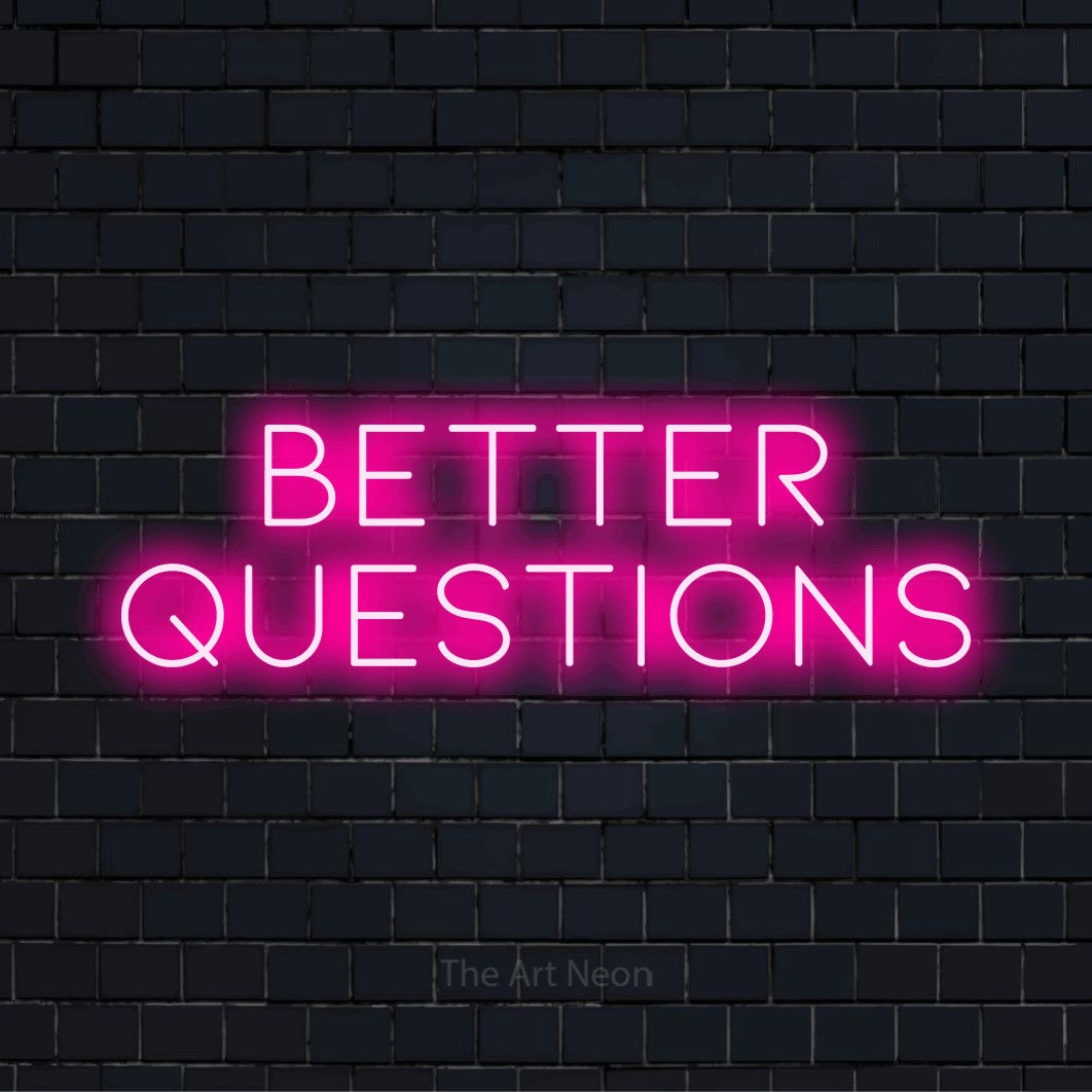 "Better Questions" LED neon sign on a black brick wall
