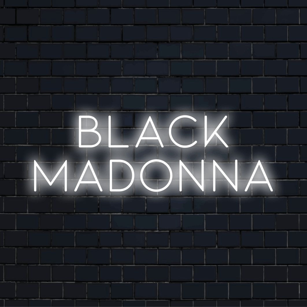 Black Madonna Neon Sign, bright neon glow against black brick wall