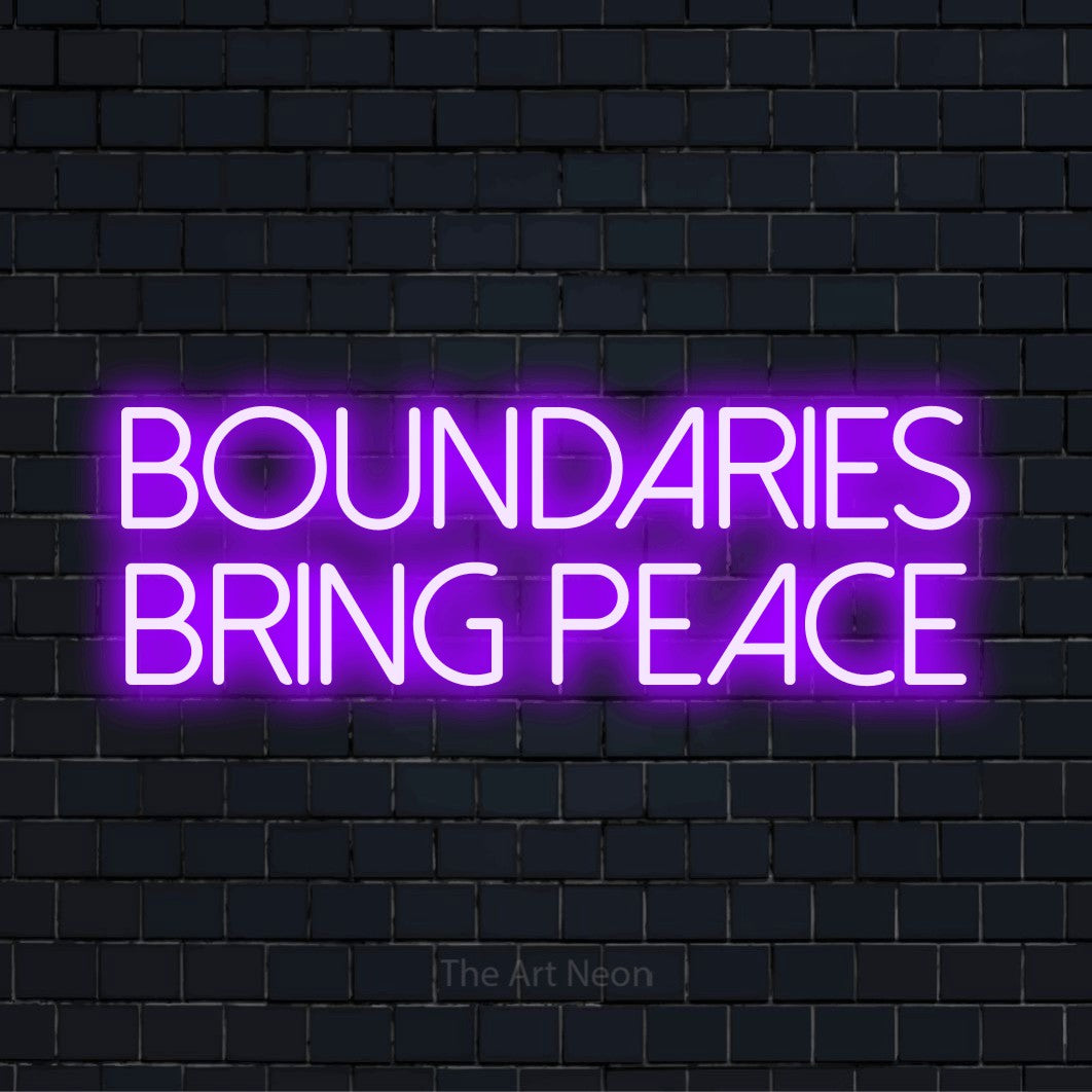 "Boundaries Bring Peace" LED neon sign on a black brick wall