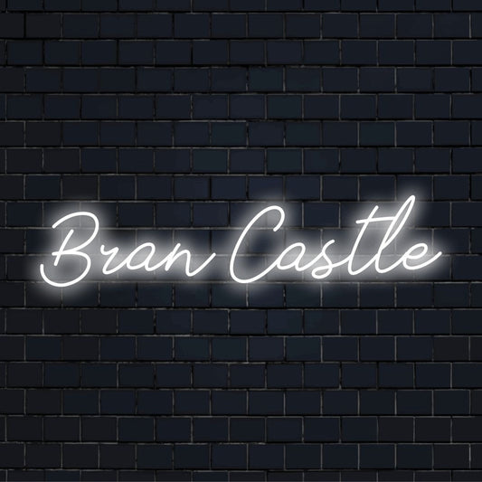 Bran Castle Neon Sign, bright LED glow against brick backdrop
