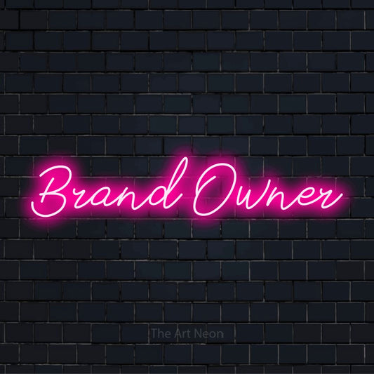 "Brand Owner" glowing LED neon sign on a black brick wall