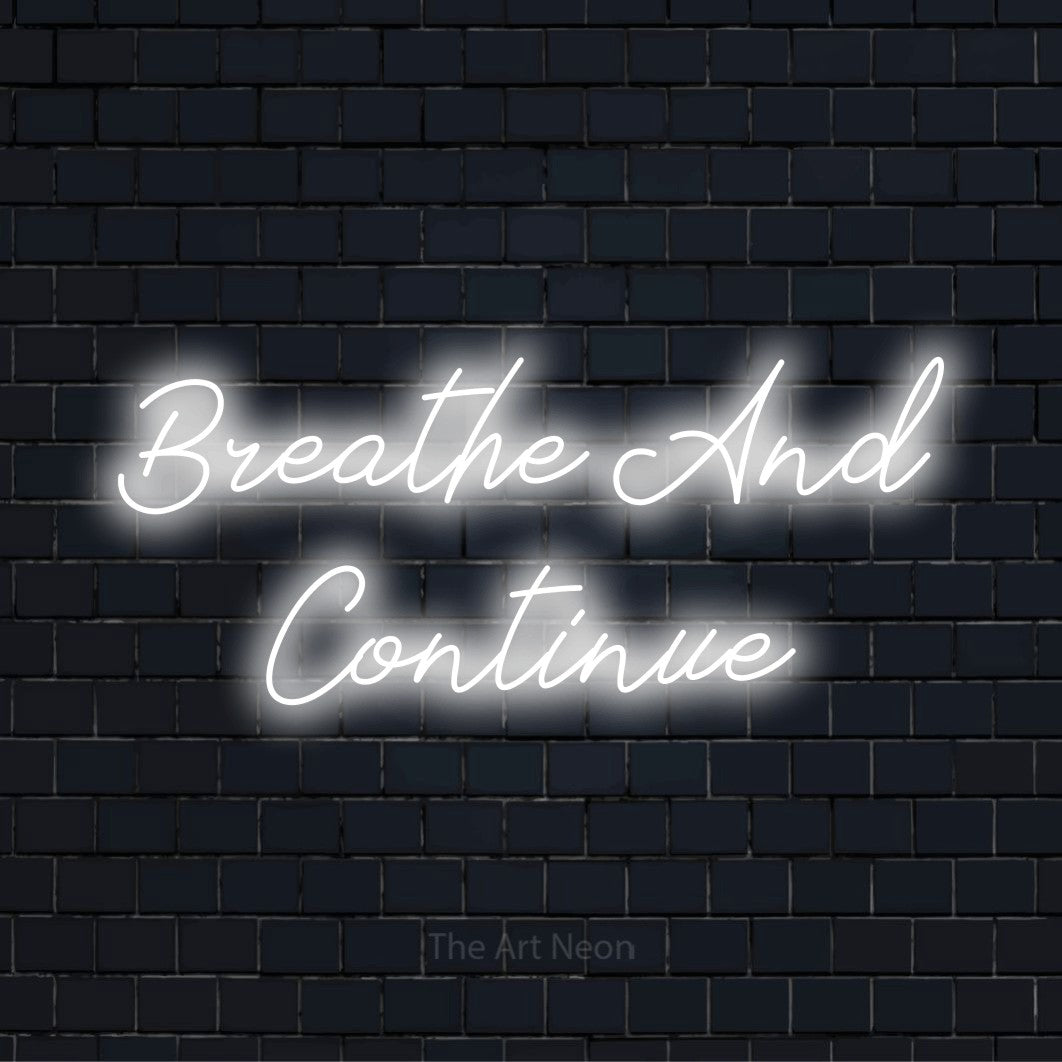 "Breathe And Continue" neon text design on a black brick wall