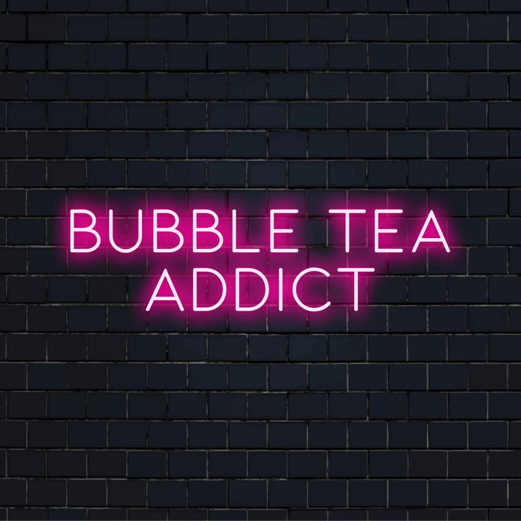 Bubble Tea Addict Neon Sign, glowing lettering against brick backdrop