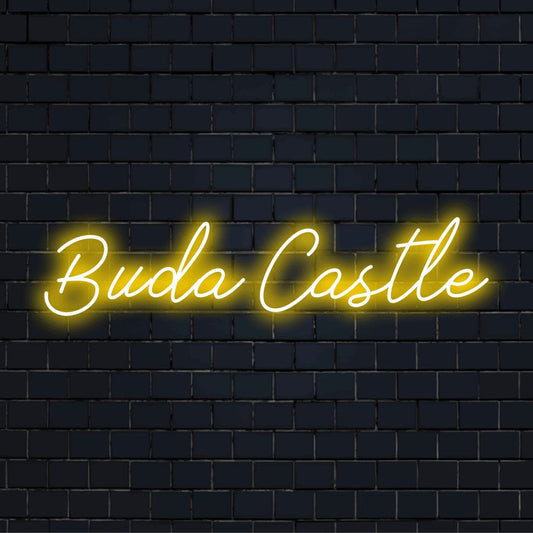 Buda Castle LED Neon Sign, glowing lettering on dark brick background