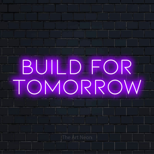 "Build For Tomorrow" neon text design on a black brick wall