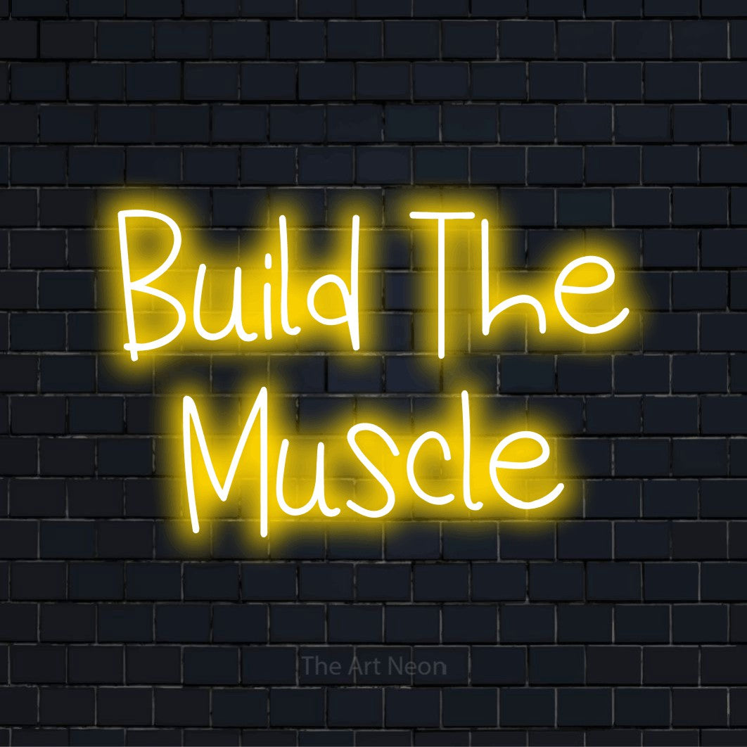 "Build The Muscle" text design with neon effect on a black brick wall