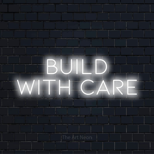 "Build With Care" text design with neon effect on a black brick wall