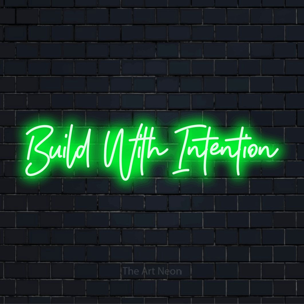 "Build With Intention" LED neon sign on a black brick wall