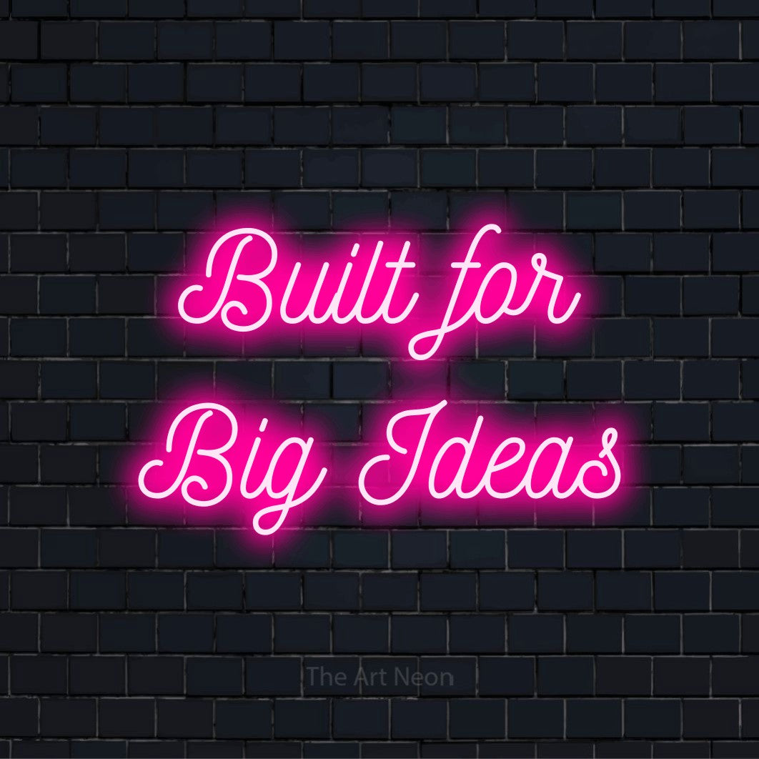 "Built For Big Ideas" glowing LED neon sign on a black brick wall