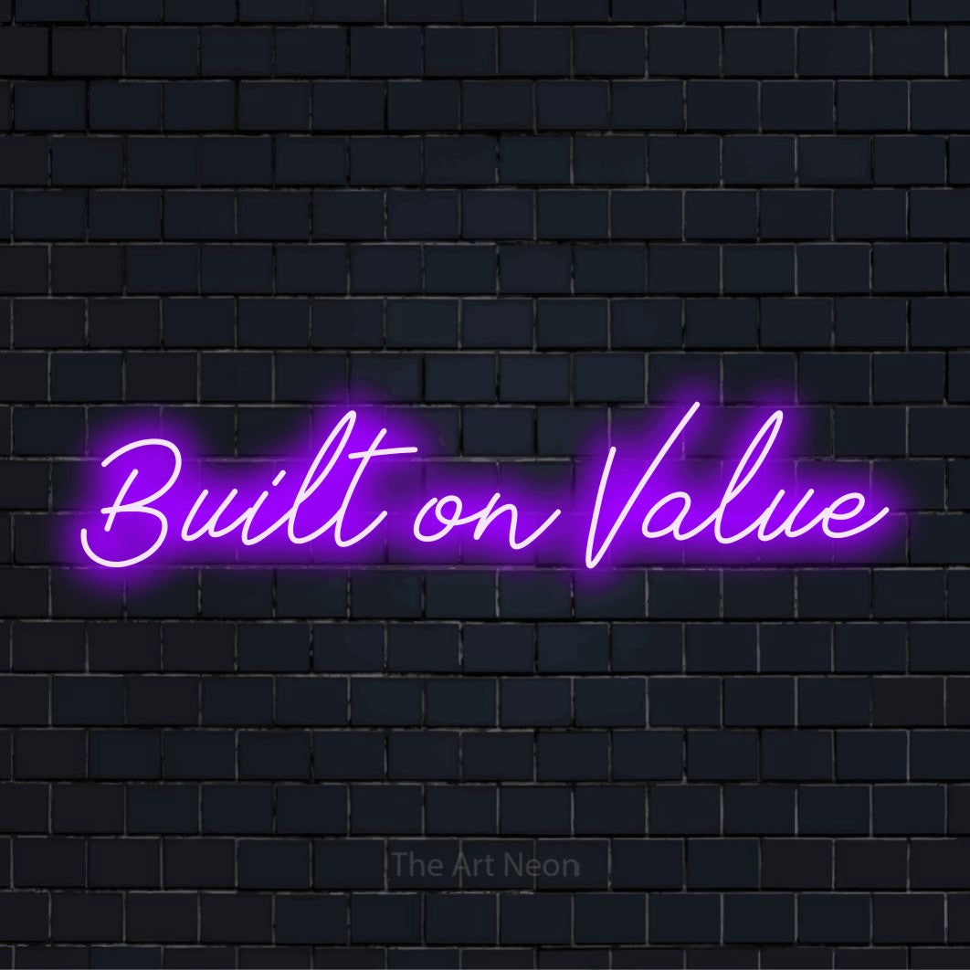 "Built On Value" text design with neon effect on a black brick wall