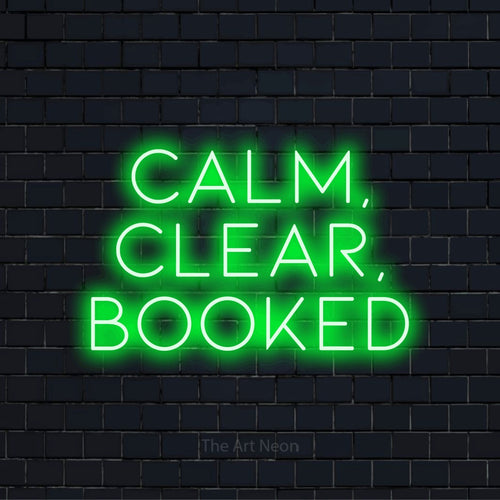 "Calm, Clear, Booked" glowing LED neon sign on a black brick wall