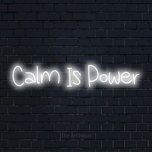 "Calm Is Power" text design with neon effect on a black brick wall