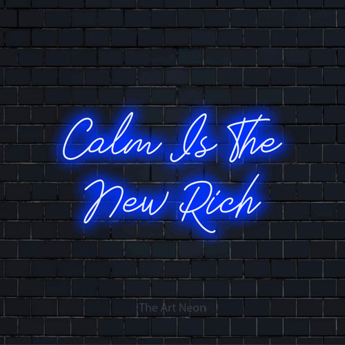"Calm Is The New Rich" neon text design on a black brick wall