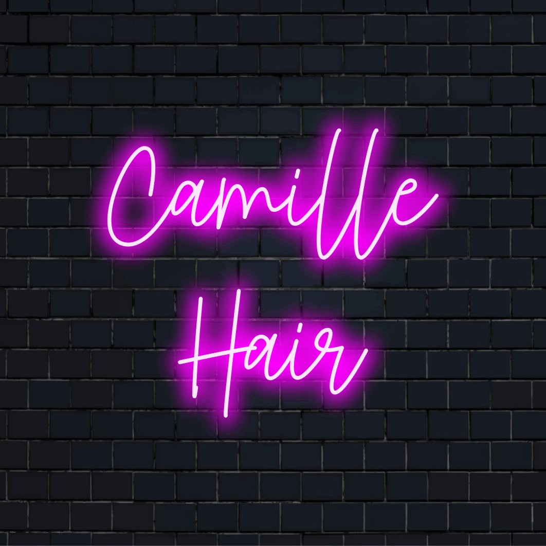 Camille Hair Custom Name Neon Sign, bright neon glow against black brick wall