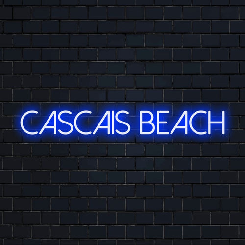 Cascais Beach Neon Sign, bright neon lettering against brick backdrop