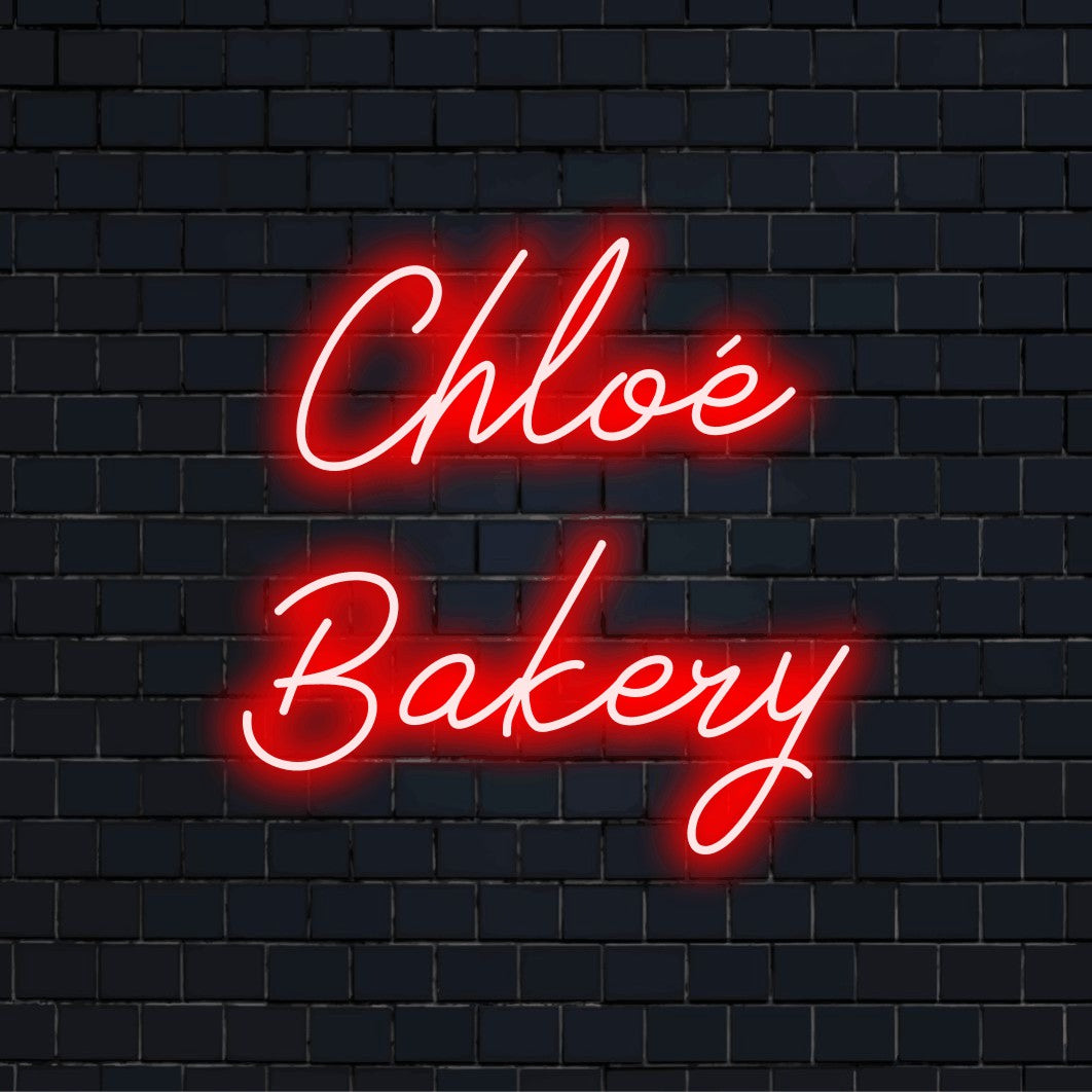 Chloe Bakery Custom Name Neon Sign, glowing lettering against brick backdrop