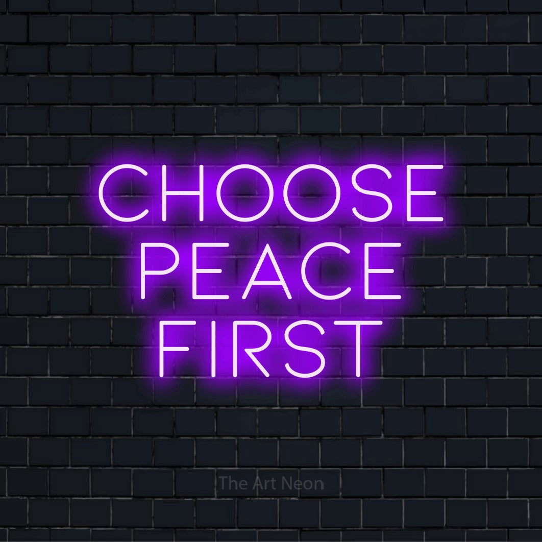 "Choose Peace First" neon text design on a black brick wall
