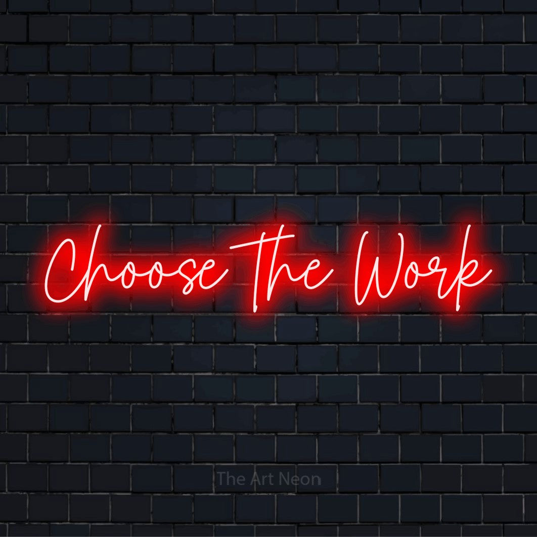 "Choose The Work" glowing LED neon sign on a black brick wall