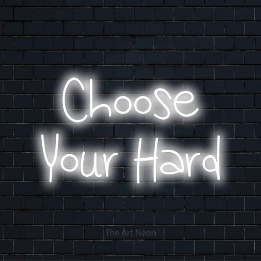 "Choose Your Hard" LED neon sign on a black brick wall