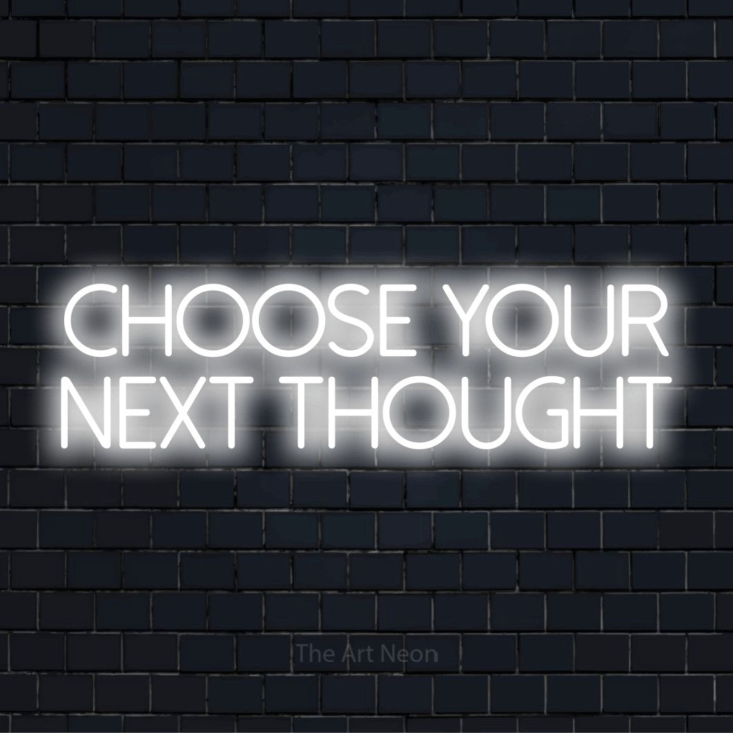 "Choose Your Next Thought" text design with neon effect on a black brick wall