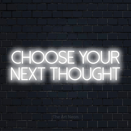 "Choose Your Next Thought" text design with neon effect on a black brick wall