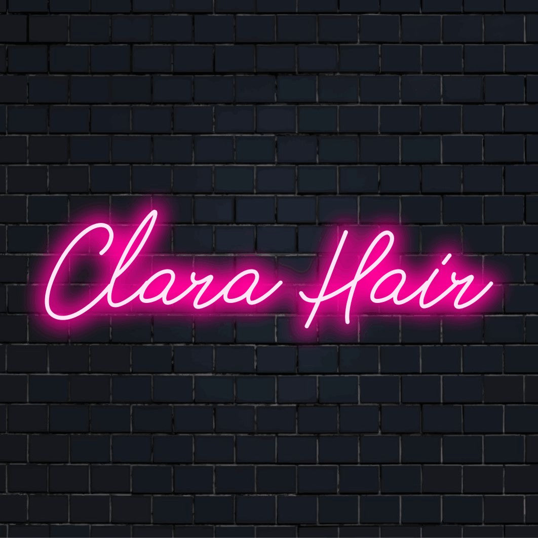 Clara Hair Personalized Neon Light with glowing lettering against brick backdrop