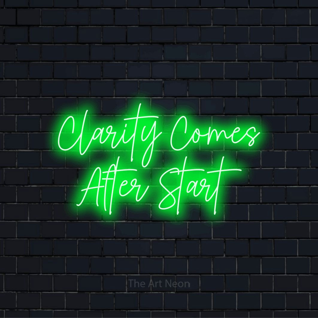 "Clarity Comes After Start" text design with neon effect on a black brick wall