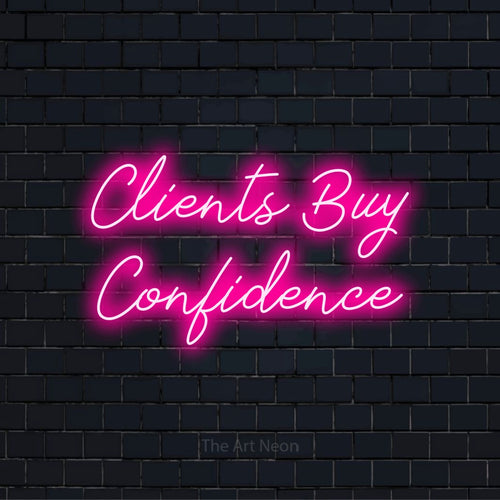"Clients Buy Confidence" glowing LED neon sign on a black brick wall