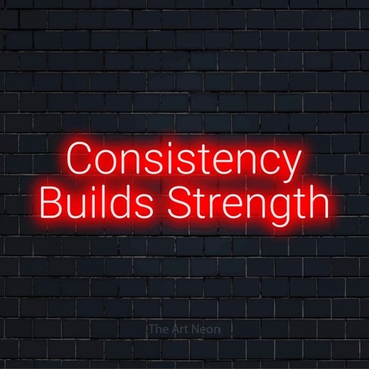 "Consistency Builds Strength" LED neon sign on a black brick wall