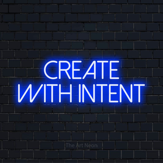 "Create With Intent" glowing LED neon sign on a black brick wall
