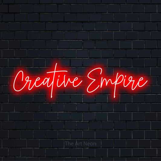 "Creative Empire" glowing LED neon sign on a black brick wall