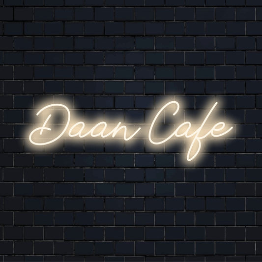 Daan Cafe Custom Name Neon Sign, glowing lettering against black brick wall