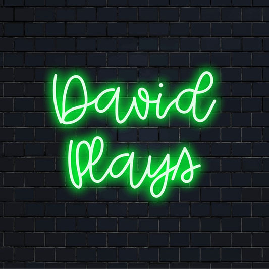 David Plays Personalized LED Neon Sign, bright neon lettering against black brick wall