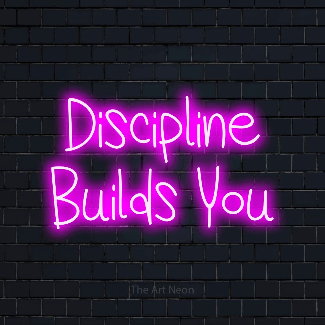"Discipline Builds You" text design with neon effect on a black brick wall