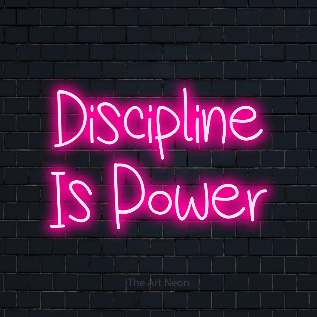 "Discipline Is Power" neon text design on a black brick wall