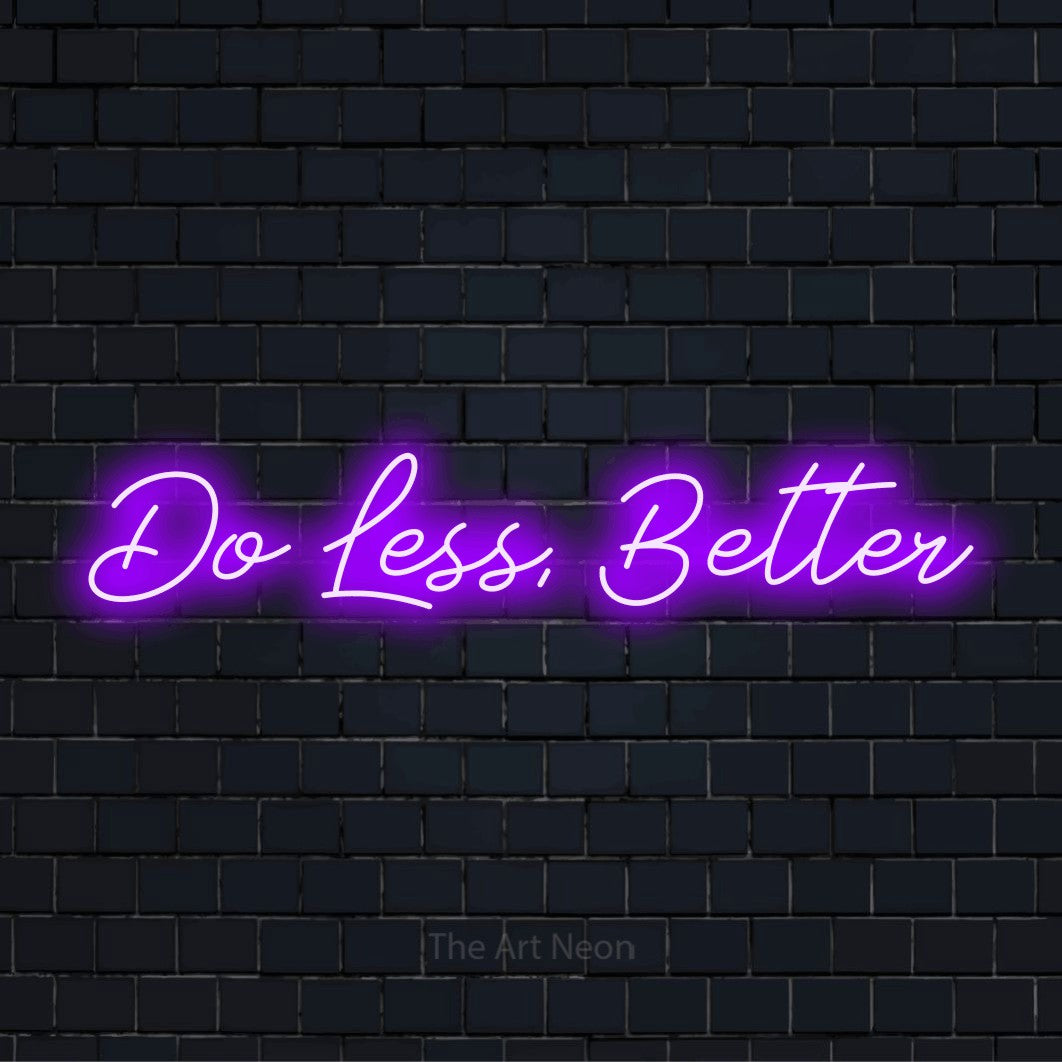 "Do Less, Better" neon text design on a black brick wall