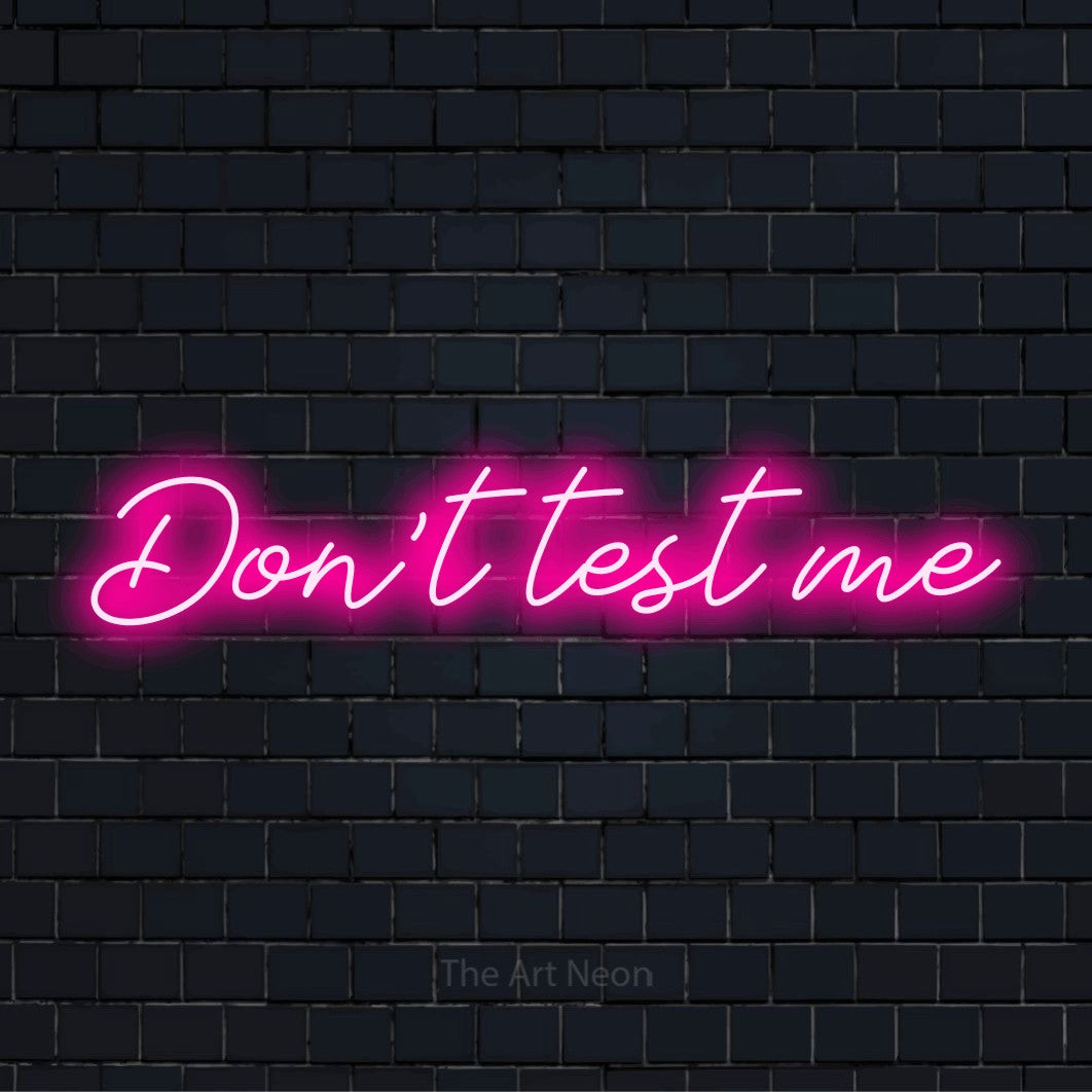 "Don’t Test Me" LED neon sign on a black brick wall
