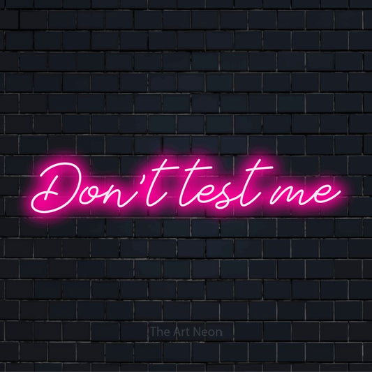 "Don’t Test Me" LED neon sign on a black brick wall