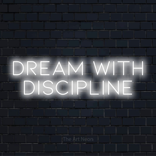 "Dream With Discipline" neon text design on a black brick wall