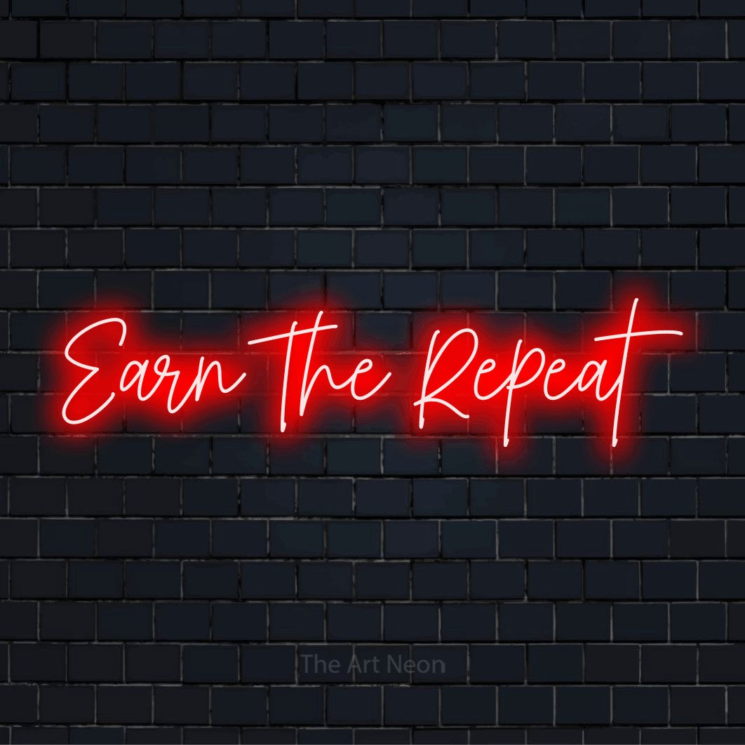 "Earn The Repeat" text design with neon effect on a black brick wall