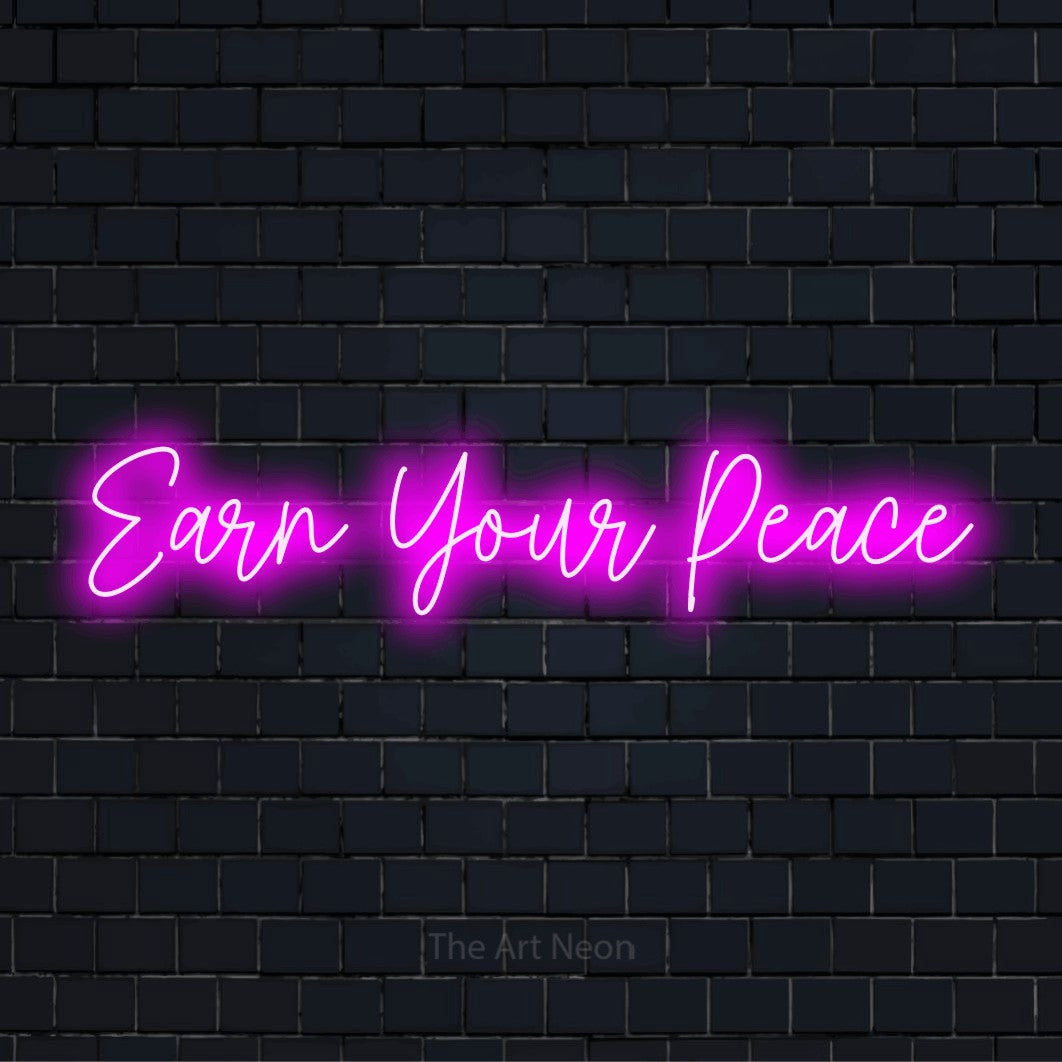 "Earn Your Peace" script-style LED neon sign on a black brick wall