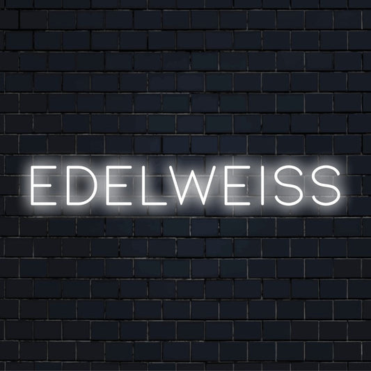 Edelweiss LED Neon Sign, bright neon lettering on black brick background