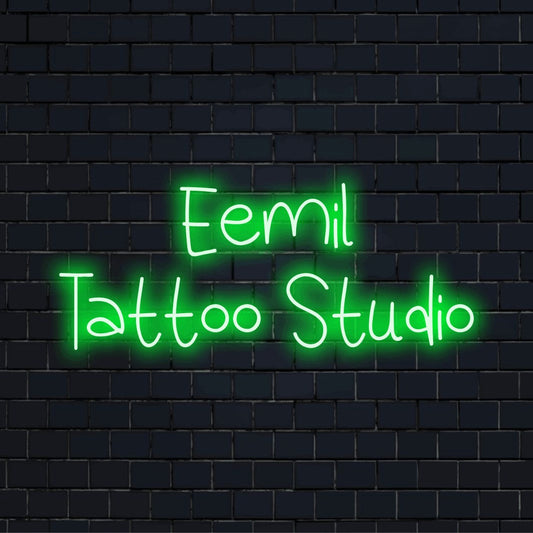 Eemil Tattoo Studio Personalized Neon Light with glowing wall decor against brick backdrop