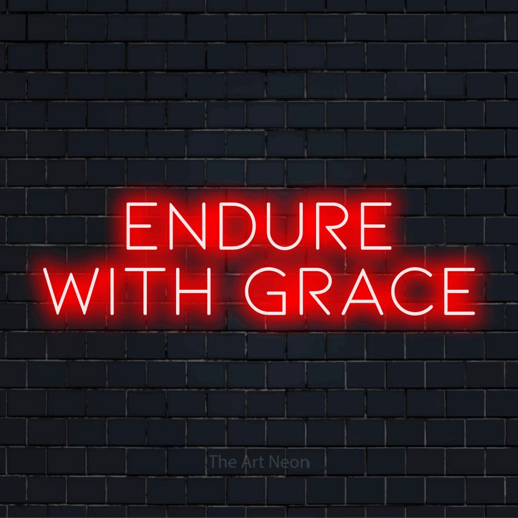 "Endure With Grace" script-style LED neon sign on a black brick wall