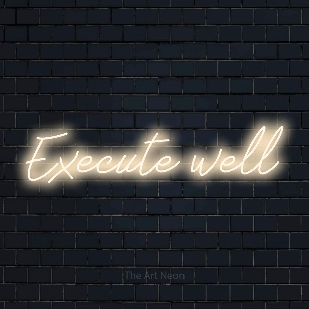 "Execute Well" LED neon sign on a black brick wall