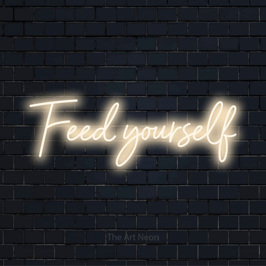 "Feed Yourself" text design with neon effect on a black brick wall