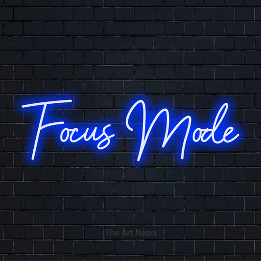 "Focus Mode" neon text design on a black brick wall