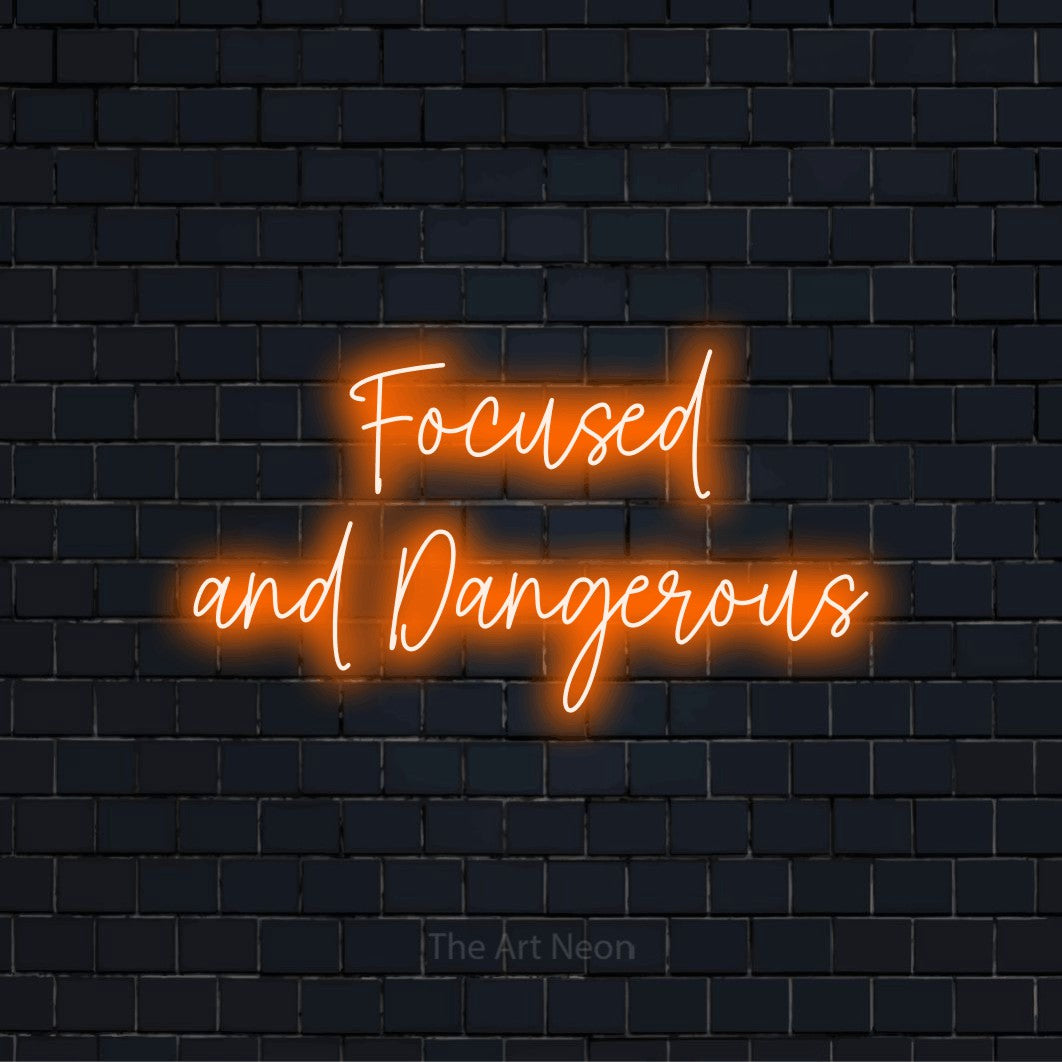 "Focused And Dangerous" neon text design on a black brick wall