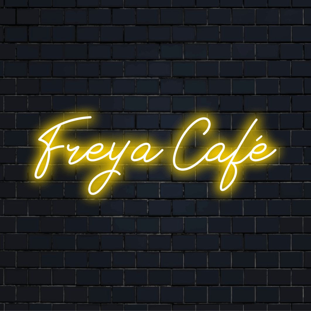 Freya Cafe Custom Name Neon Sign, glowing wall decor against brick backdrop